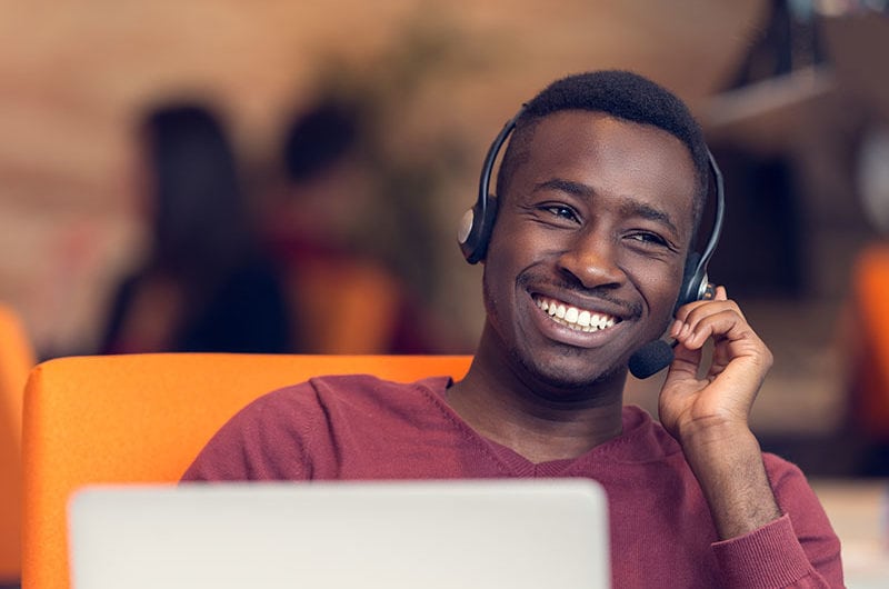 Man with headphones smiling.